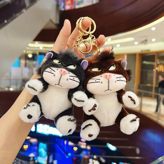 Mr. Grumps black plush keychain held in hand inside a store